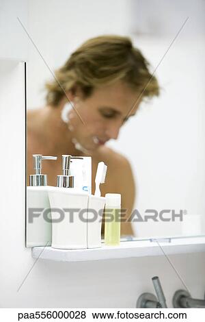 Man with shaving cream on face reflected in bathroom mirror View Large Photo Image Stock Photo - Man with shaving cream on face reflected in bathroom mirror. Fotosearch
