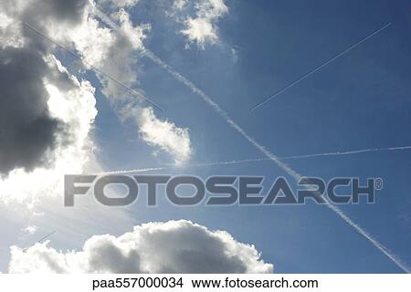 Blue sky with clouds and vapor trails View Large Photo Image Picture - Blue sky with clouds and vapor trails. Fotosearch