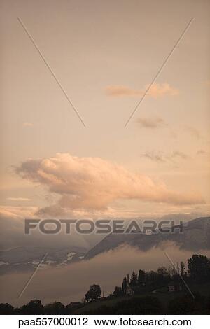 Stock Image - Clouds over mountain landscape. Fotosearch