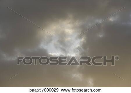 Sky visible through opening in clouds View Large Photo Image Stock Photo - Sky visible through opening in clouds. Fotosearch