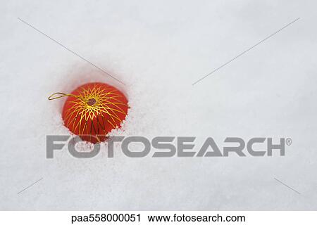 Christmas ornament half buried in snow, high angle view View Large Photo Image Stock Image - Christmas ornament half buried in snow, high angle view. Fotosearch