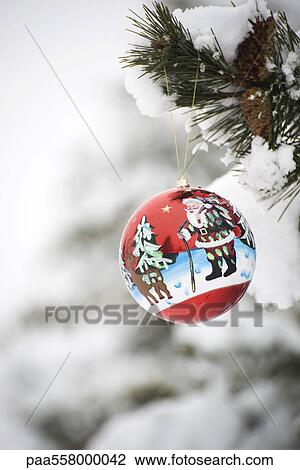 Colorful Christmas ornament hanging from snow-covered branch View Large Photo Image Stock Image - Colorful Christmas ornament hanging from snow-covered branch. Fotosearch