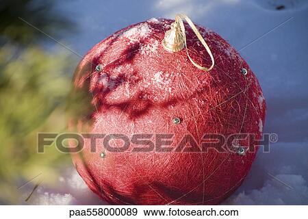 Red Christmas ornament on snowy ground View Large Photo Image Stock Photo - Red Christmas ornament on snowy ground. Fotosearch