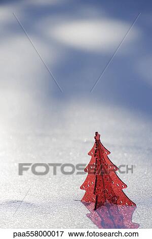 Red plastic Christmas tree decoration set in snow View Large Photo Image Stock Photo - Red plastic Christmas tree decoration set in snow. Fotosearch