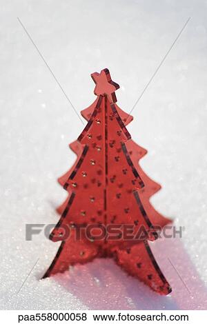 Red plastic Christmas tree decoration set in snow View Large Photo Image Stock Photo - Red plastic Christmas tree decoration set in snow. Fotosearch