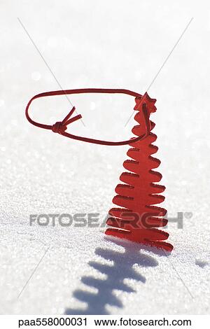 Red wooden Christmas tree decoration set in snow View Large Photo Image Stock Image - Red wooden Christmas tree decoration set in snow. Fotosearch