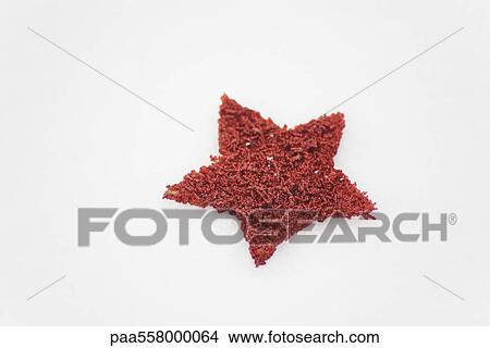 Picture - Solitary red star placed on snow. Fotosearch
