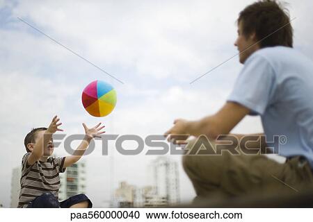 Father and son playing with ball View Large Photo Image Stock Image - Father and son playing with ball. Fotosearch