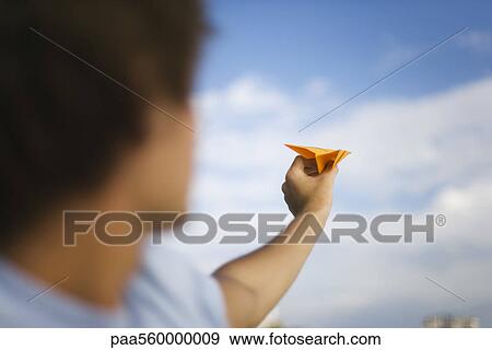 Stock Photo - Man throwing paper airplane. Fotosearch