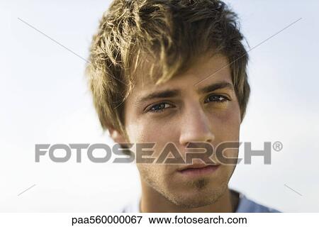 Young man looking at camera, portrait View Large Photo Image Stock Photo - Young man looking at camera, portrait. Fotosearch