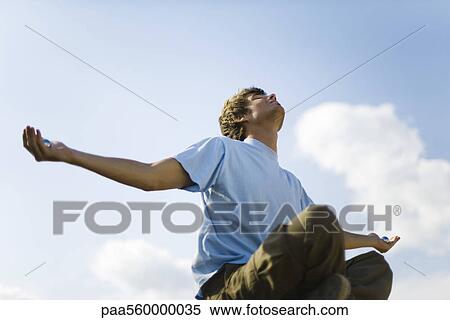 Young man meditating outdoors, holding yin yang balls View Large Photo Image Stock Photography - Young man meditating outdoors, holding yin yang balls. Fotosearch