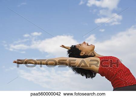 Young woman bending over backwards, laughing View Large Photo Image Stock Image - Young woman bending over backwards, laughing. Fotosearch