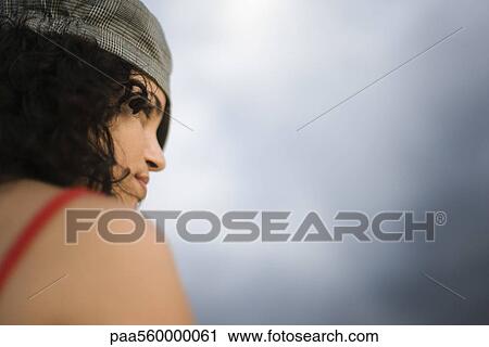 Young woman looking away, over shoulder view View Large Photo Image Stock Image - Young woman looking away, over shoulder view. Fotosearch
