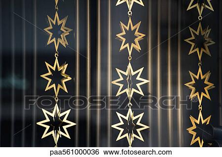 Stock Photograph - Golden star-shaped garlands. Fotosearch