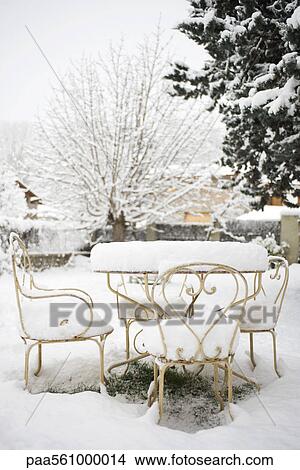 Patio furniture covered with thick layer of snow View Large Photo Image Picture - Patio furniture covered with thick layer of snow. Fotosearch