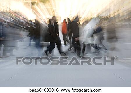 Stock Photograph - Pedestrians crossing street, blurred. Fotosearch