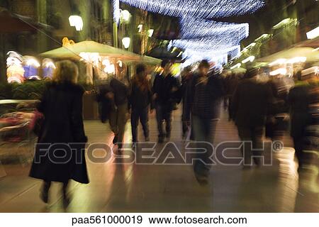 Stock Photo - Pedestrians walking on pedestrian street at night, blurred. Fotosearch