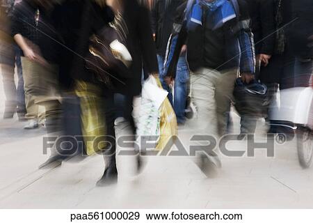 Pedestrians walking on sidewalk, blurred View Large Photo Image Stock Photo - Pedestrians walking on sidewalk, blurred. Fotosearch