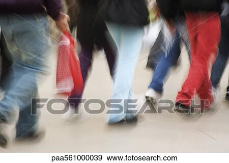 Stock Photo - Pedestrians walking on sidewalk, low section. Fotosearch