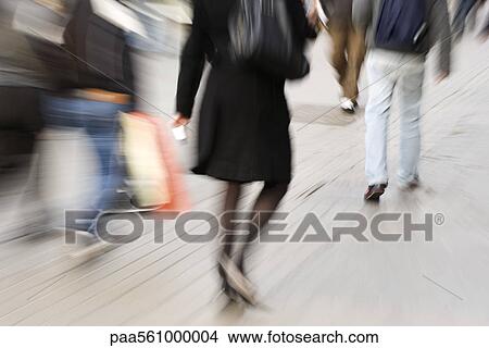 Pedestrians walking on sidewalk, rear view, blurred View Large Photo Image Picture - Pedestrians walking on sidewalk, rear view, blurred. Fotosearch