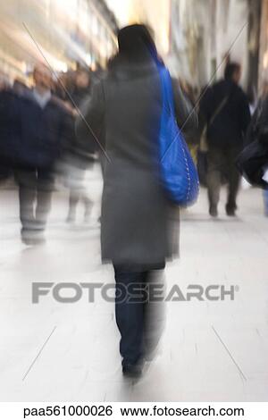 Pedestrians walking on sidewalk, rear view, blurred View Large Photo Image Stock Photograph - Pedestrians walking on sidewalk, rear view, blurred. Fotosearch