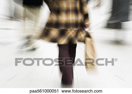 Shopper walking with shopping bag in hand, rear view, cropped View Large Photo Image Stock Image - Shopper walking with shopping bag in hand, rear view, cropped. Fotosearch
