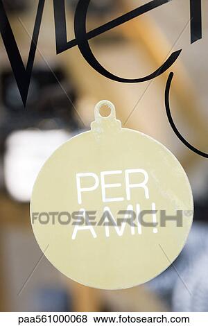 Stock Photo - Sign shaped like Christmas ornament in shop window, proclaiming "per a mi, " ("for me" in Catalan). Fotosearch
