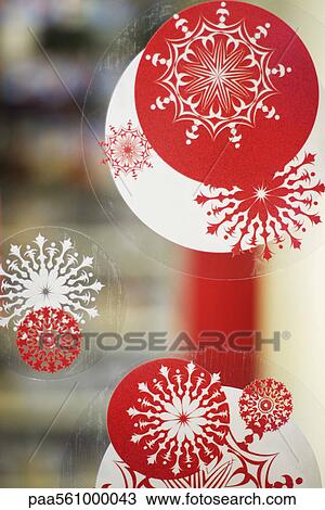 Stock Image - Window decorated with Christmas decals, close-up. Fotosearch