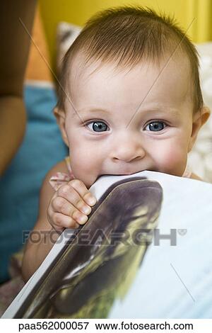Baby chewing on metal baking sheet View Large Photo Image Stock Photo - Baby chewing on metal baking sheet. Fotosearch