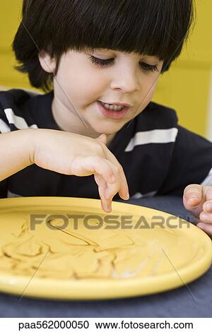 Little boy drawing on plate with finger View Large Photo Image Stock Image - Little boy drawing on plate with finger. Fotosearch
