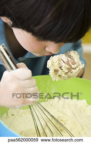 Little boy leaning over mixing bowl, smelling handful of dough View Large Photo Image Stock Photo - Little boy leaning over mixing bowl, smelling handful of dough. Fotosearch