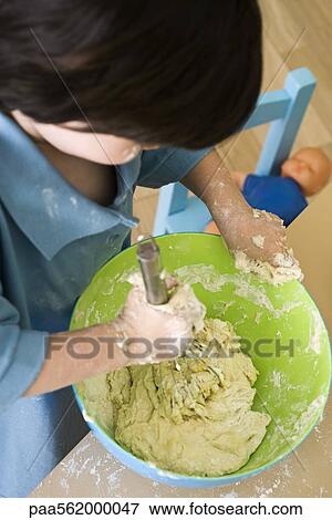 Little boy mixing batter, high angle view View Large Photo Image Stock Photo - Little boy mixing batter, high angle view. Fotosearch