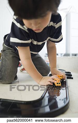 Little boy playing with cars on plastic track View Large Photo Image Stock Image - Little boy playing with cars on plastic track. Fotosearch