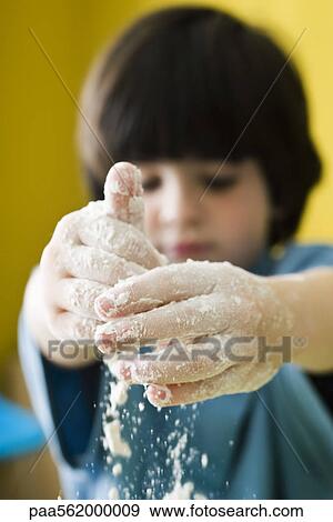 Stock Photo - Little boy playing with flour. Fotosearch