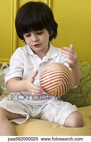 Little boy playing with striped ball View Large Photo Image Stock Photography - Little boy playing with striped ball. Fotosearch