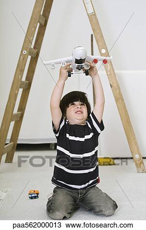 Little boy playing with toy airplane View Large Photo Image Stock Image - Little boy playing with toy airplane. Fotosearch