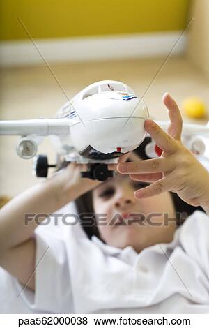 Little boy playing with toy airplane View Large Photo Image Stock Photo - Little boy playing with toy airplane. Fotosearch