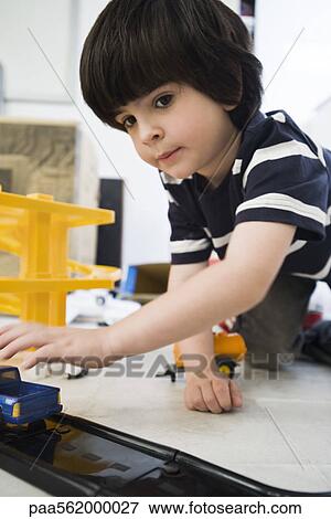 Little boy playing with toy cars, close-up View Large Photo Image Stock Photo - Little boy playing with toy cars, close-up. Fotosearch