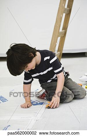 Little boy playing with toy truck on floor View Large Photo Image Stock Image - Little boy playing with toy truck on floor. Fotosearch