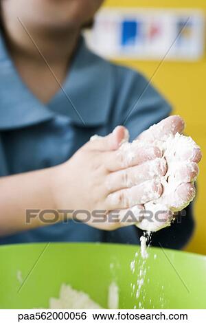 Little boy sifting flour into mixing bowl with hands, cropped View Large Photo Image Stock Photograph - Little boy sifting flour into mixing bowl with hands, cropped. Fotosearch