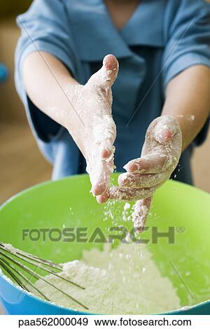 Little boy sprinkling flour into mixing bowl View Large Photo Image Stock Photo - Little boy sprinkling flour into mixing bowl. Fotosearch