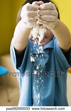 Little boy with hands raised, sprinkling flour View Large Photo Image Stock Image - Little boy with hands raised, sprinkling flour. Fotosearch
