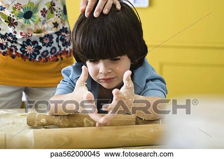 Little boy with messy hands baking with mother, cropped View Large Photo Image Stock Photography - Little boy with messy hands baking with mother, cropped. Fotosearch
