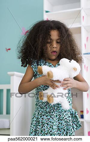 Little girl holding stuffed sheep View Large Photo Image Stock Image - Little girl holding stuffed sheep. Fotosearch