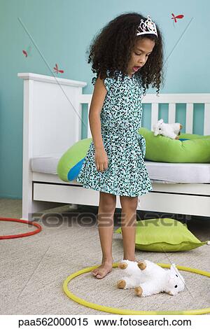Little girl playing with plastic hoop and stuffed toy in bedroom View Large Photo Image Stock Photography - Little girl playing with plastic hoop and stuffed toy in bedroom. Fotosearch