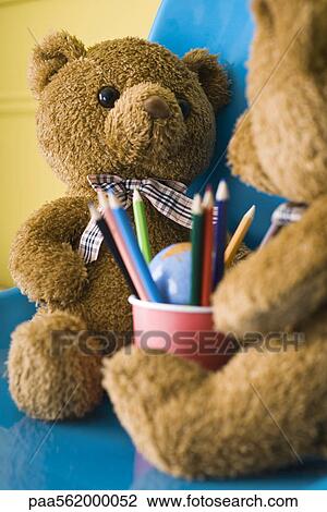 Teddy bears seated face to face with cup of colored pencils between them View Large Photo Image Stock Image - Teddy bears seated face to face with cup of colored pencils between them. Fotosearch