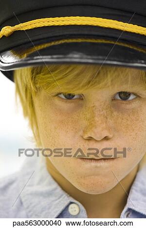 Boy wearing police officer's cap looking sternly at camera View Large Photo Image Stock Image - Boy wearing police officer's cap looking sternly at camera. Fotosearch