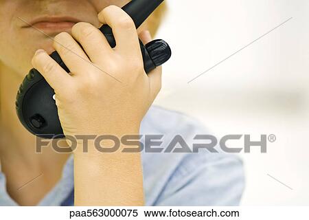 Stock Photography - Child with walkie-talkie, cropped. Fotosearch