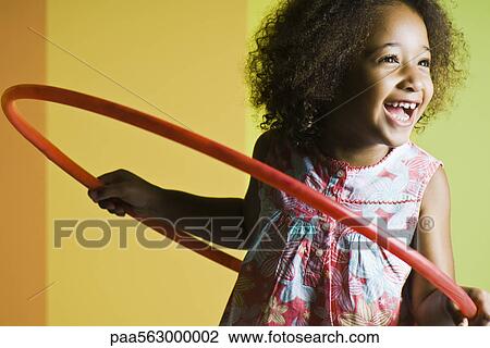 Girl playing with plastic hoop View Large Photo Image Stock Image - Girl playing with plastic hoop. Fotosearch
