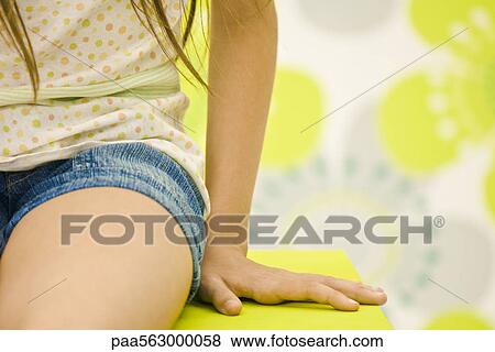 Girl, sitting with hand resting beside her on table, cropped View Large Photo Image Stock Photo - Girl, sitting with hand resting beside her on table, cropped. Fotosearch